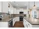 Modern kitchen with white cabinets, granite countertops, and stainless steel appliances at 626 Notting Hill Ct., Conway, SC 29526