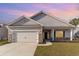 Newly constructed home with gray siding, a two-car garage, and a well-manicured lawn at 643 Woodside Dr., Conway, SC 29526