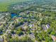 Aerial view of community features mature trees, manicured lawns, a lake, and winding streets with beautiful homes at 6716 Wisteria Dr., Myrtle Beach, SC 29588