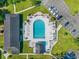 Aerial view of the community pool area with pool, lounge chairs, picnic area, parking lot, and lush landscaping at 6716 Wisteria Dr., Myrtle Beach, SC 29588