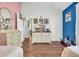 Shared bedroom featuring hardwood floors, unique color-blocked walls, and a TV at 6716 Wisteria Dr., Myrtle Beach, SC 29588