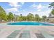 Spacious community pool with lounge chairs and lush green trees surrounding the area at 6716 Wisteria Dr., Myrtle Beach, SC 29588