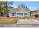 Charming single-story home with a manicured lawn, inviting entrance, and a gray exterior at 6716 Wisteria Dr., Myrtle Beach, SC 29588