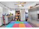 Organized garage with storage cabinets, a refrigerator, and colorful floor tiles at 6716 Wisteria Dr., Myrtle Beach, SC 29588