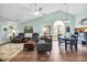 Spacious living room with vaulted ceilings, modern furniture, and abundant natural light from a large window at 6716 Wisteria Dr., Myrtle Beach, SC 29588