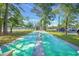 Community shuffleboard courts feature painted number markers, shade trees, and seating areas for residents at 6716 Wisteria Dr., Myrtle Beach, SC 29588