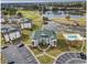 Aerial view of condo complex, lake, golf course and pool with lounge chairs at 677 Tupelo Ln. # 301, Longs, SC 29568