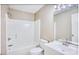 Bright bathroom with a white shower and tub combination, white sink, and a large mirror at 677 Tupelo Ln. # 301, Longs, SC 29568