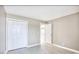 Bedroom with gray walls, wood look flooring, white trim, and double door closet at 677 Tupelo Ln. # 301, Longs, SC 29568