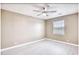 Bedroom featuring a ceiling fan, a window with blinds, and neutral wall color at 677 Tupelo Ln. # 301, Longs, SC 29568