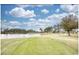 Scenic golf course view with lush green grass and a serene lake backdrop at 677 Tupelo Ln. # 301, Longs, SC 29568