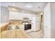 Bright kitchen with white cabinets, wood countertops, and white appliances at 677 Tupelo Ln. # 301, Longs, SC 29568