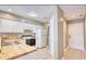 Kitchen with white cabinets, wood countertops, tile floors, and white appliances at 677 Tupelo Ln. # 301, Longs, SC 29568
