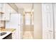 Galley kitchen features white appliances and countertops at 677 Tupelo Ln. # 301, Longs, SC 29568