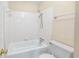 White tiled bathroom with bathtub and shower at 7602 Porcher Dr. # C, Myrtle Beach, SC 29572