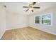 Simple bedroom with light walls, hardwood floors, and a window at 7602 Porcher Dr. # C, Myrtle Beach, SC 29572