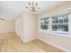 Bright dining room features hardwood floors, chandelier, and large windows at 7602 Porcher Dr. # C, Myrtle Beach, SC 29572