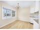 Light-filled dining area with hardwood floors and kitchen access at 7602 Porcher Dr. # C, Myrtle Beach, SC 29572