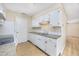 Galley kitchen with white cabinets and double sink at 7602 Porcher Dr. # C, Myrtle Beach, SC 29572