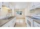 Efficient kitchen with white cabinets, stainless steel sink, and stove at 7602 Porcher Dr. # C, Myrtle Beach, SC 29572