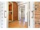 Front entry with wood-look floors, brick wall, and access to other rooms at 804 Geddings Dr., Myrtle Beach, SC 29588