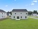 Rear view of a two-story house with gray siding and a spacious yard at 1032 Kinness Dr., Conway, SC 29527