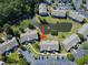 Aerial view of condominiums with a pond, landscaping, and parking, creating an inviting community setting at 1109 Peace Pipe Ln. # 201, Myrtle Beach, SC 29579