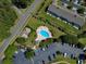 Aerial view showcasing community pool and surrounding lush landscape at 1109 Peace Pipe Ln. # 201, Myrtle Beach, SC 29579