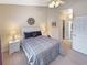 Bedroom featuring ceiling fan, neutral paint, and doorway to closet and ensuite bath at 1109 Peace Pipe Ln. # 201, Myrtle Beach, SC 29579