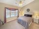 Comfortable bedroom with a ceiling fan, a large window, and neutral color scheme at 1109 Peace Pipe Ln. # 201, Myrtle Beach, SC 29579