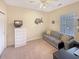 Versatile bedroom with neutral colors, ceiling fan, comfortable sofa, and bright natural light at 1109 Peace Pipe Ln. # 201, Myrtle Beach, SC 29579