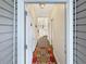 Bright hallway featuring wood floors, neutral walls, and a colorful rug creating a warm welcome at 1109 Peace Pipe Ln. # 201, Myrtle Beach, SC 29579