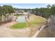 Scenic aerial view of a golf course with a pond, green, and people enjoying a round at 112 Staton Ln., Longs, SC 29568