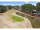 Overhead view of a manicured golf course featuring a pond and lush green next to waterfront homes at 112 Staton Ln., Longs, SC 29568