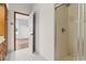 Bathroom features a shower stall, white tile floor, and a connecting door to the bedroom at 112 Staton Ln., Longs, SC 29568