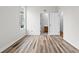 Bedroom with a large window, wood floors, white walls, and a view to bathroom at 112 Staton Ln., Longs, SC 29568