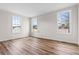 Bright bedroom with three windows and laminate wood flooring at 112 Staton Ln., Longs, SC 29568