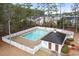 Overhead shot of neighborhood pool; features white picket fence and bath house surrounded by trees at 112 Staton Ln., Longs, SC 29568