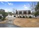 View of the exterior of this two-story home, featuring an ample driveway and detached garage at 112 Staton Ln., Longs, SC 29568