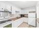 Updated kitchen featuring white appliances and cabinets, and tile backsplash at 112 Staton Ln., Longs, SC 29568