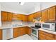 Functional kitchen with wooden cabinets, stainless steel appliances, and well-lit countertop space at 112 Staton Ln., Longs, SC 29568