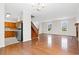Open-concept living space with hardwood floors, fireplace and staircase, adjacent to the kitchen area at 112 Staton Ln., Longs, SC 29568