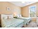 Two twin beds with teal and white bedding in a bright bedroom at 114 Scotchbroom Dr. # M101, Little River, SC 29566