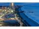 Aerial view of a lit coastline at night, featuring a ferris wheel and fishing pier at 1209 Peyton Ct., Myrtle Beach, SC 29588