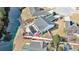 Aerial view of a backyard with a pool, a patio, and a white privacy fence with a water view at 1209 Peyton Ct., Myrtle Beach, SC 29588