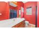 Bathroom featuring a bright red wall color, tiled floor, and a large mirror at 1209 Peyton Ct., Myrtle Beach, SC 29588