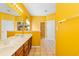 Well-lit bathroom with double sink vanity, bright yellow walls, and tiled flooring at 1209 Peyton Ct., Myrtle Beach, SC 29588