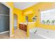 Bright bathroom with soaking tub, tiled floors, and a vanity with cabinet storage at 1209 Peyton Ct., Myrtle Beach, SC 29588