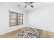 This bedroom has a window, a ceiling fan, neutral carpet, and light gray walls at 1209 Peyton Ct., Myrtle Beach, SC 29588
