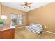 Bedroom with neutral carpet, tan walls, ceiling fan, window, and a futon on the floor at 1209 Peyton Ct., Myrtle Beach, SC 29588